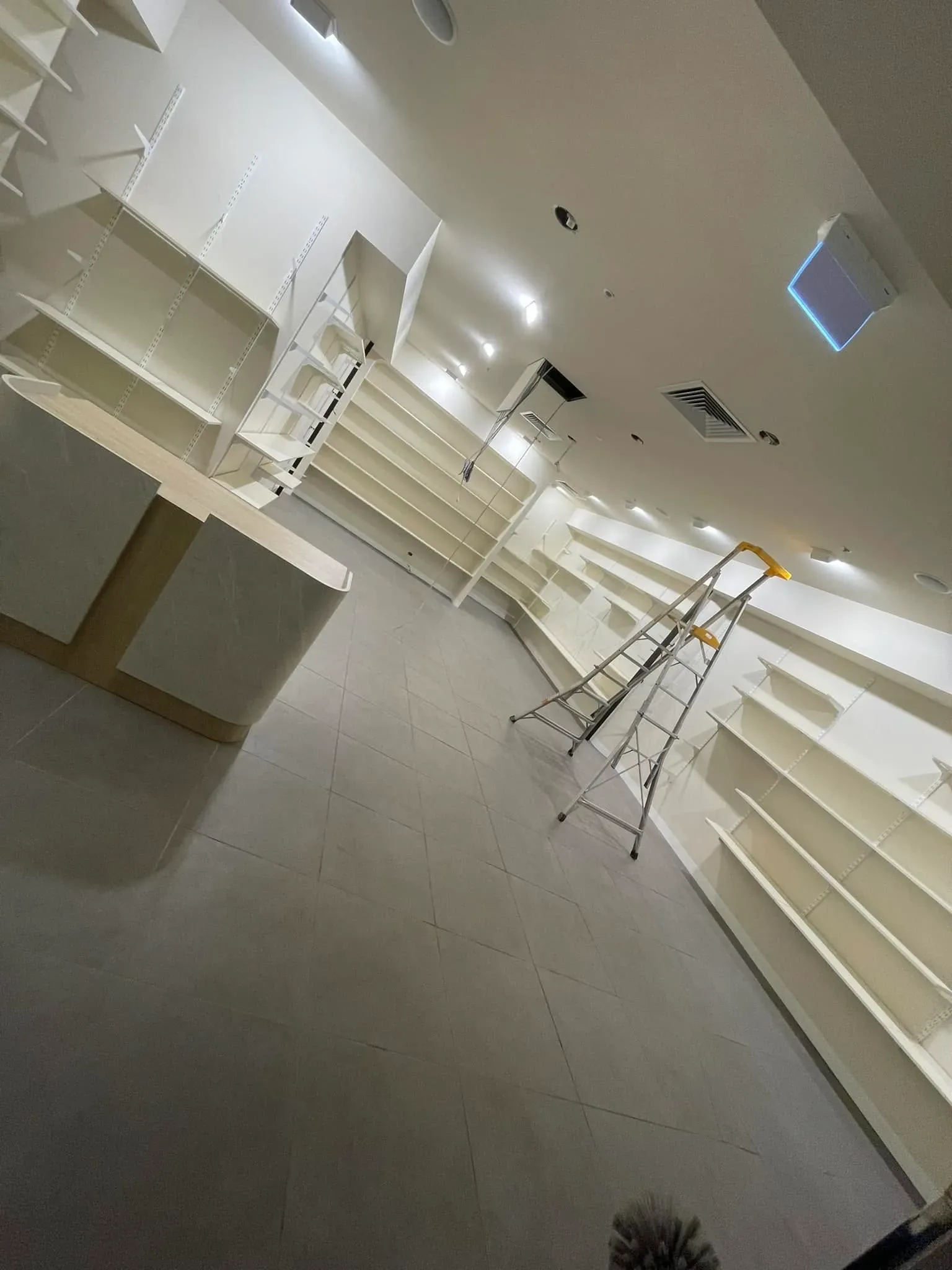 Newly finished commercial interior with clean floors, counters and shelving