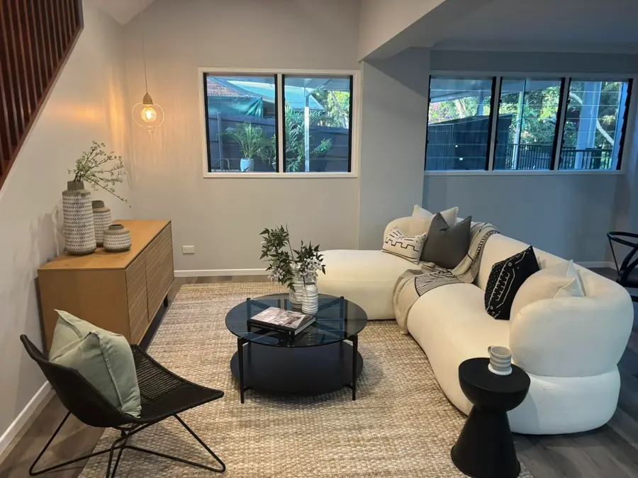 Freshly presented living room with sofa, rug and clean hard floors